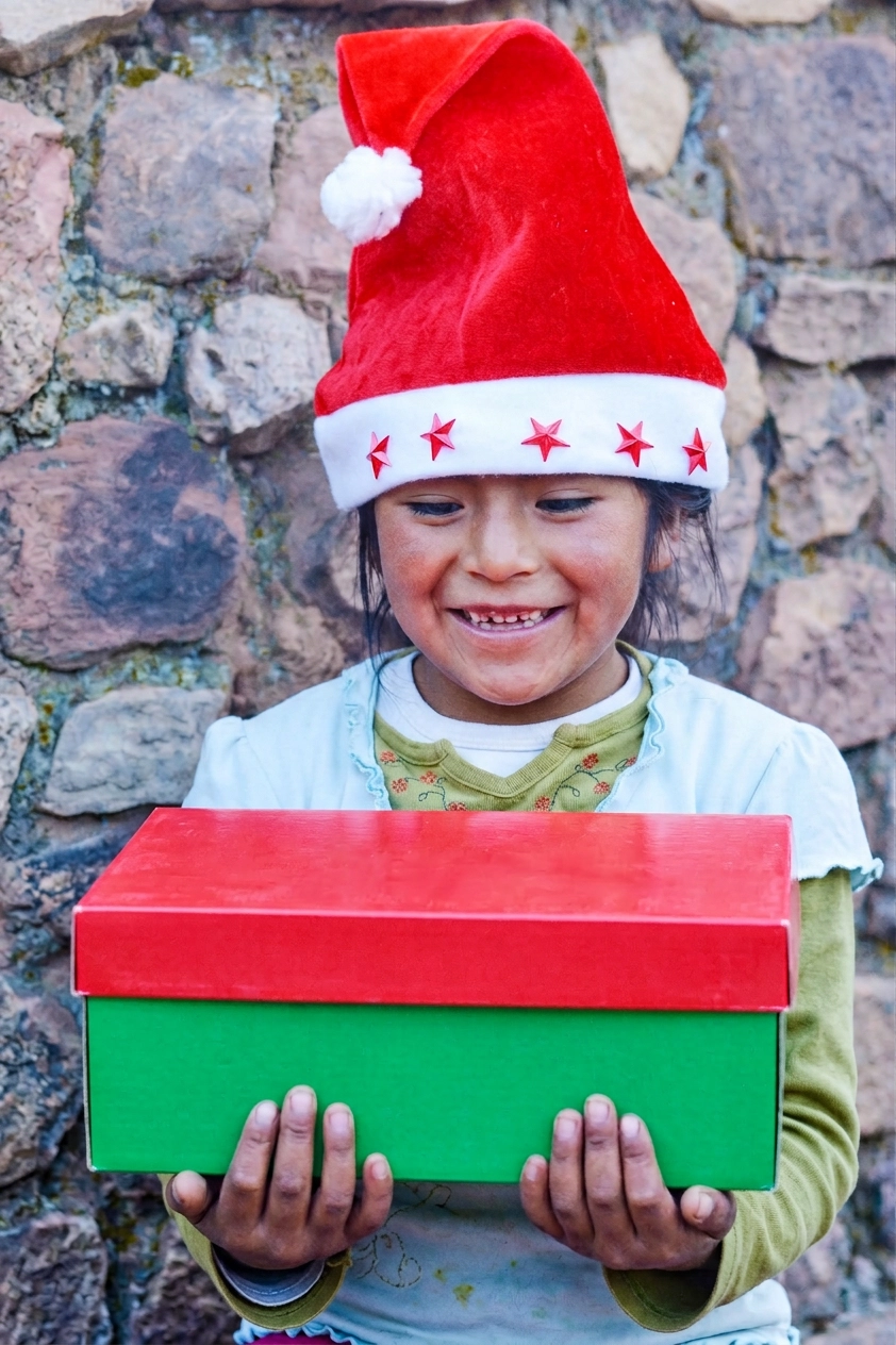 Girl holding a green and red shoebox
